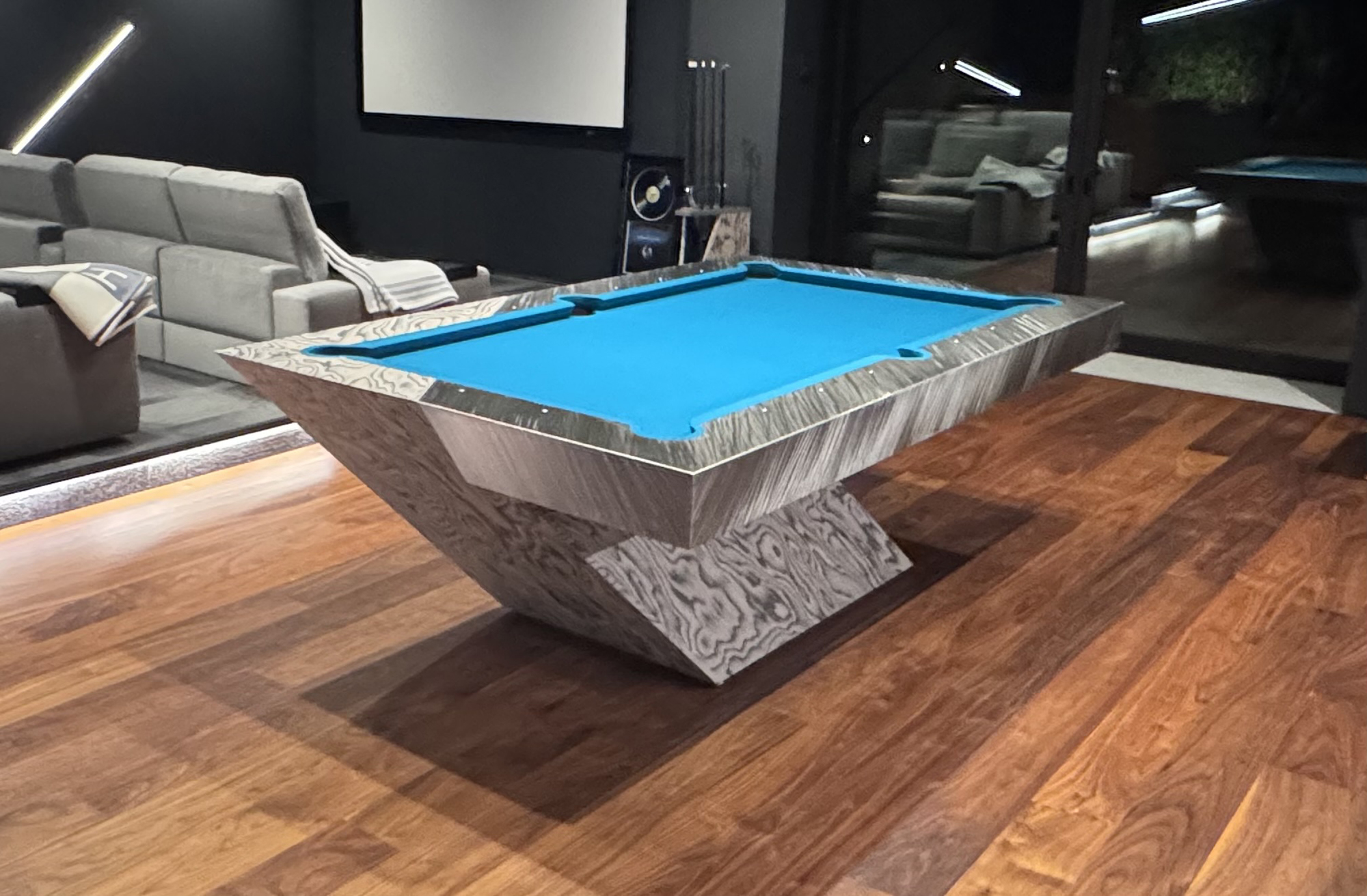 Detail of the sculptural Optimus table in a completed media room